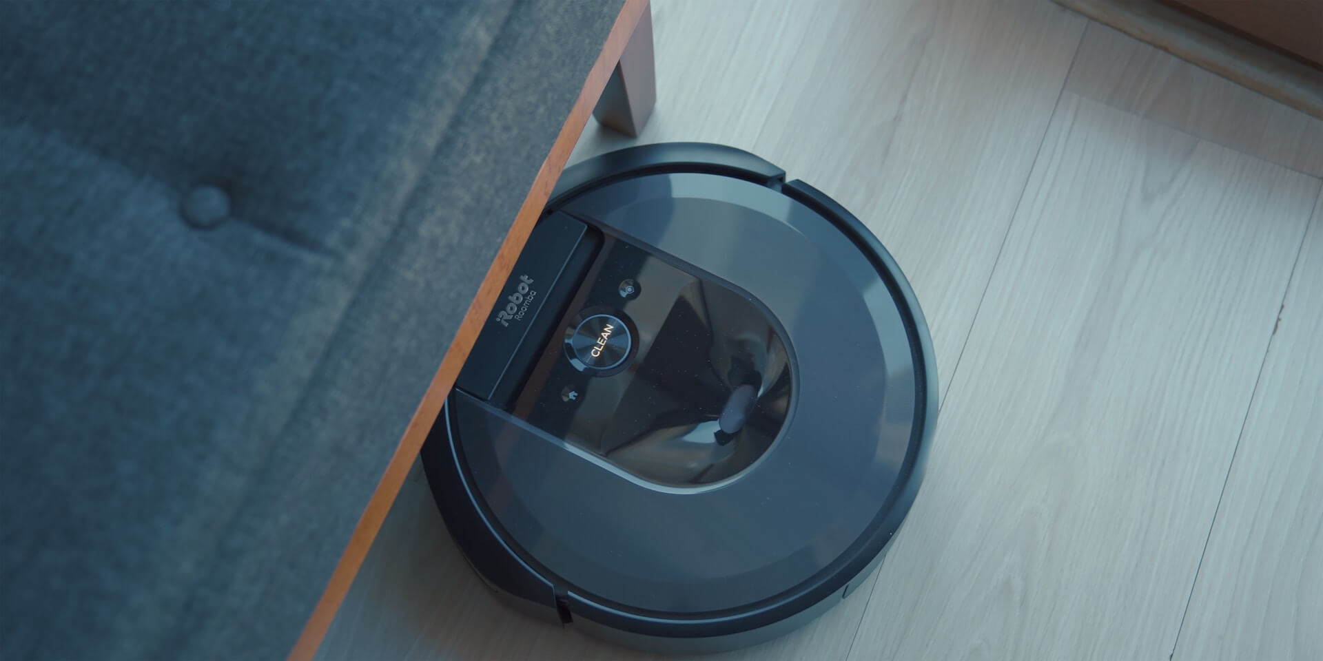a robot vacuum cleaner going under a sofa